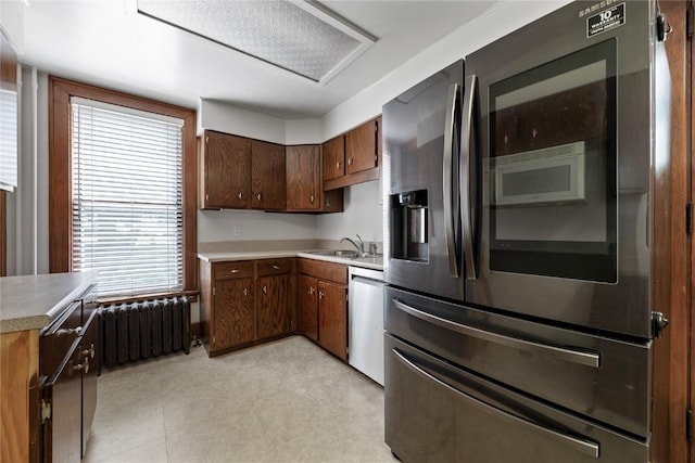 103 10th Ave SW, Mount Vernon, IA 52314 - kitchen with appliances with stainless steel finishes, radiator heating unit, and light countertops