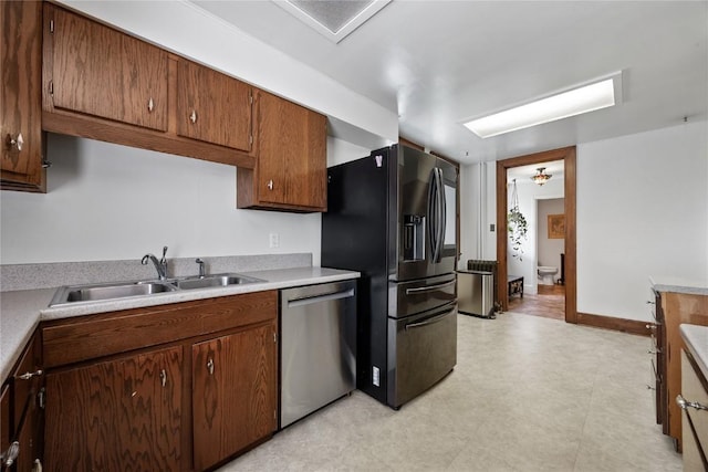 103 10th Ave SW, Mount Vernon, IA 52314 - kitchen featuring dishwasher, black fridge with ice dispenser, light countertops, and brown cabinetry