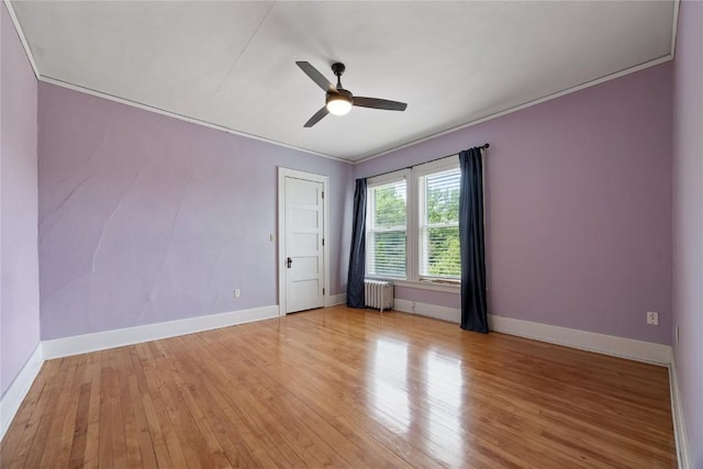 103 10th Ave SW, Mount Vernon, IA 52314 - empty room featuring radiator, ceiling fan, light wood-style flooring, and ornamental molding