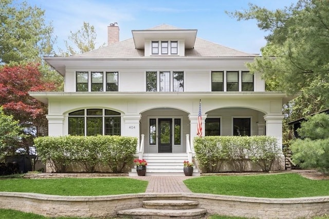 404 Brown St, Iowa City, IA 52245 - traditional style home with a porch, a chimney, and a front yard