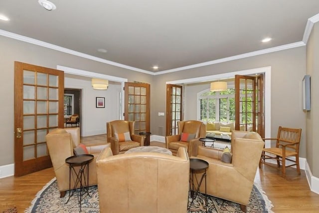 404 Brown St, Iowa City, IA 52245 - sitting room with french doors, light wood-style floors, ornamental molding, and recessed lighting