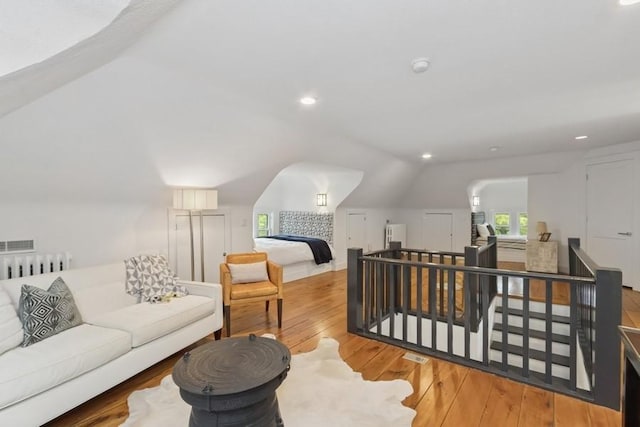 404 Brown St, Iowa City, IA 52245 - living area featuring an upstairs landing, vaulted ceiling, hardwood / wood-style floors, recessed lighting, and radiator