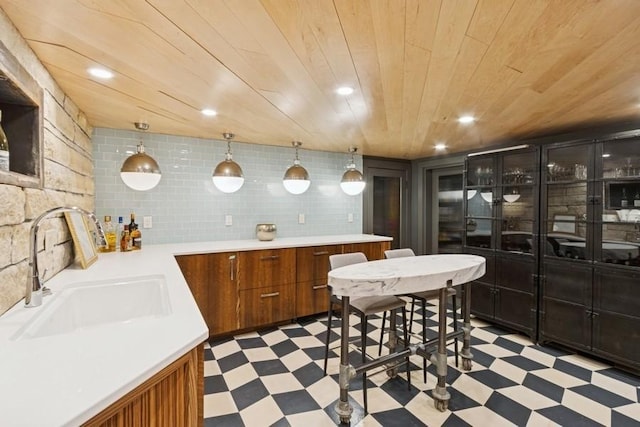 404 Brown St, Iowa City, IA 52245 - kitchen with light floors, brown cabinets, wooden ceiling, light countertops, and recessed lighting