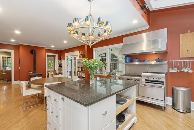404 Brown St, Iowa City, IA 52245 - kitchen featuring wall chimney exhaust hood, open shelves, light wood-type flooring, ornamental molding, and white cabinetry