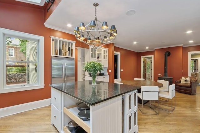 404 Brown St, Iowa City, IA 52245 - kitchen featuring a chandelier, open shelves, ornamental molding, light wood-style floors, and a wood stove