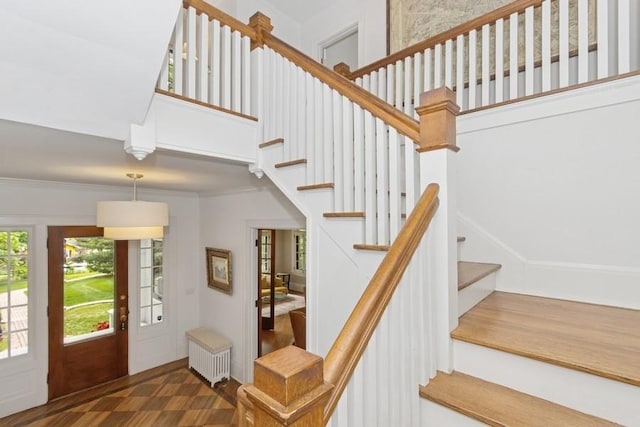404 Brown St, Iowa City, IA 52245 - stairway featuring radiator heating unit and a towering ceiling