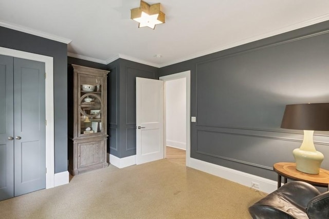 404 Brown St, Iowa City, IA 52245 - living area featuring light colored carpet, ornamental molding, and a decorative wall