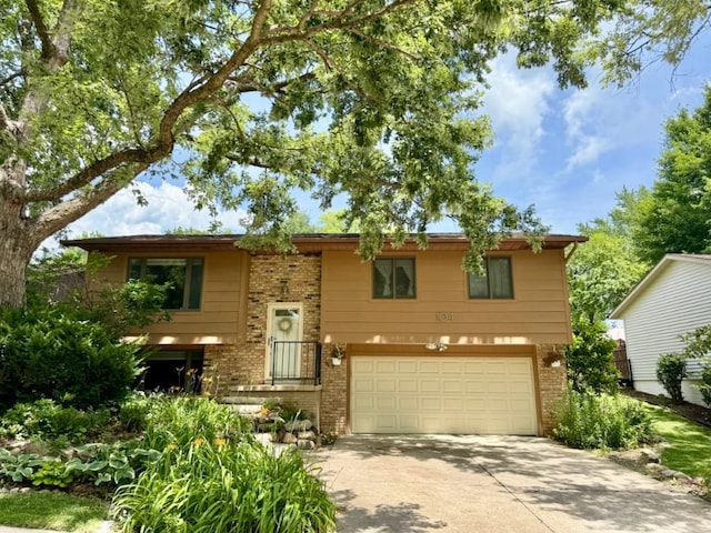 104 Oberlin St, Iowa City, IA 52245 - split foyer home with brick siding, driveway, and an attached garage