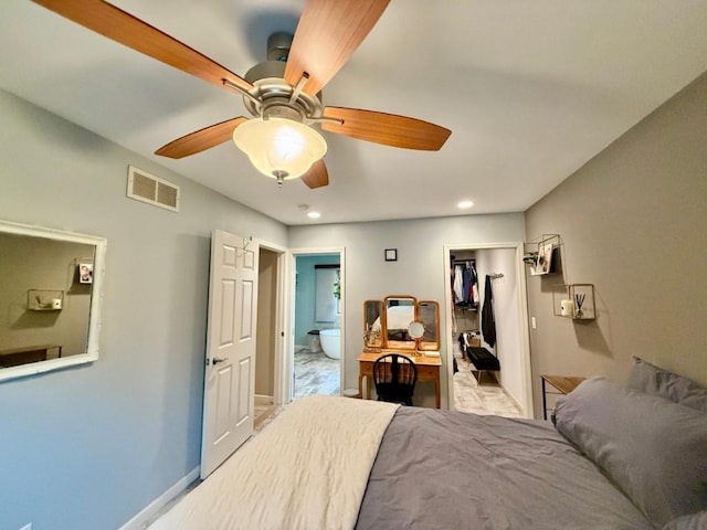 104 Oberlin St, Iowa City, IA 52245 - bedroom featuring connected bathroom, a walk in closet, a ceiling fan, a closet, and recessed lighting