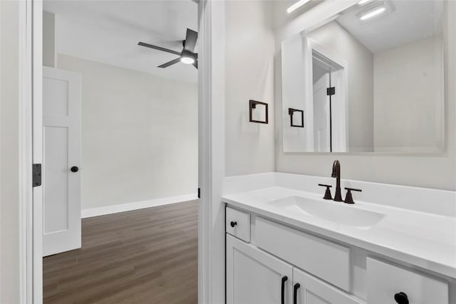 1356 Hinkley Ave NW, Cedar Rapids, IA 52405 - bathroom with wood finished floors, vanity, and a ceiling fan
