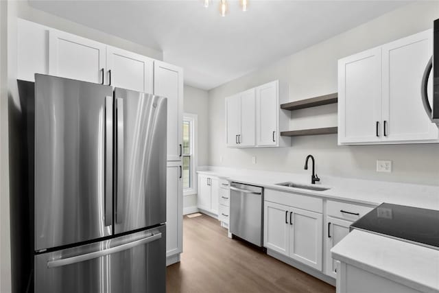 1356 Hinkley Ave NW, Cedar Rapids, IA 52405 - kitchen featuring appliances with stainless steel finishes, open shelves, dark wood-type flooring, white cabinets, and light countertops