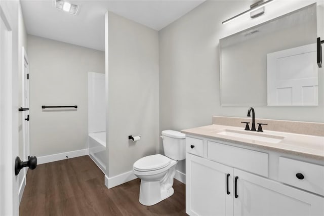 1356 Hinkley Ave NW, Cedar Rapids, IA 52405 - bathroom featuring vanity, wood finished floors, and washtub / shower combination