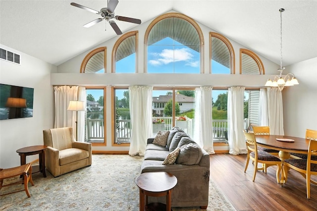 1459 Buckingham Ln, Iowa City, IA 52245 - living area featuring wood finished floors, a chandelier, ceiling fan, and high vaulted ceiling