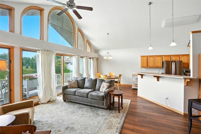 1459 Buckingham Ln, Iowa City, IA 52245 - living area with a ceiling fan, high vaulted ceiling, dark wood-style flooring, and a chandelier