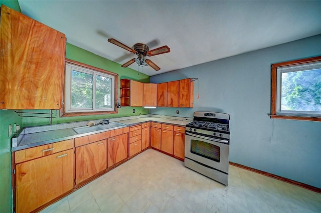 1640 11th St NW, Cedar Rapids, IA 52405 - kitchen with stainless steel gas range oven, healthy amount of natural light, and light floors