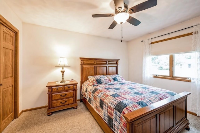 1595 17th Ave, Marion, IA 52302 - bedroom with light colored carpet and a ceiling fan