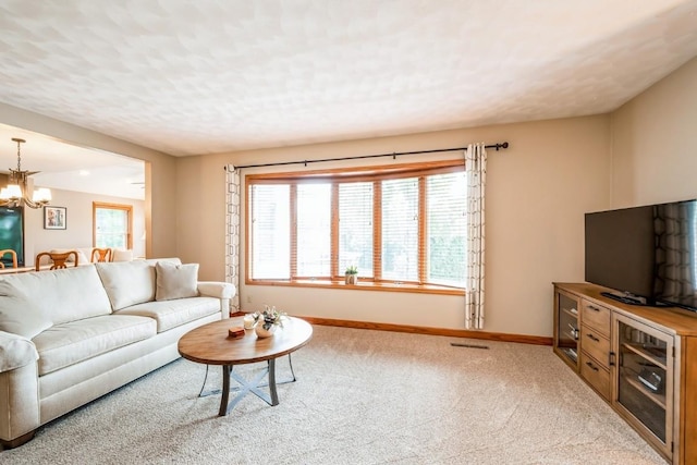 1595 17th Ave, Marion, IA 52302 - living room with a chandelier, carpet floors, and a textured ceiling