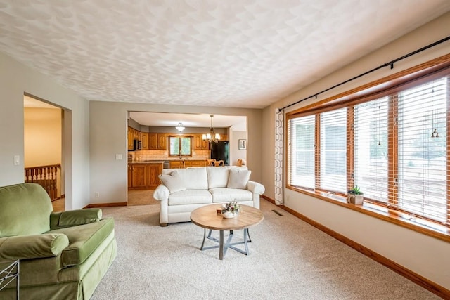 1595 17th Ave, Marion, IA 52302 - living area featuring light colored carpet and a chandelier