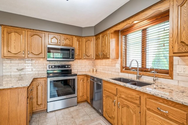 1595 17th Ave, Marion, IA 52302 - kitchen with appliances with stainless steel finishes, light stone counters, and decorative backsplash