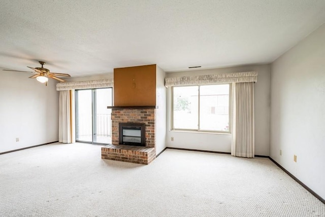 809 Kerry Ln SE Unit 66, Cedar Rapids, IA 52403 - unfurnished living room with carpet floors, ceiling fan, and a fireplace