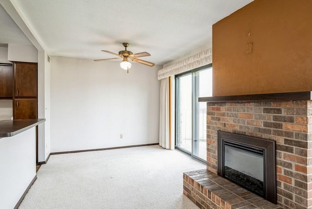 809 Kerry Ln SE Unit 66, Cedar Rapids, IA 52403 - unfurnished living room with light carpet, ceiling fan, and a brick fireplace