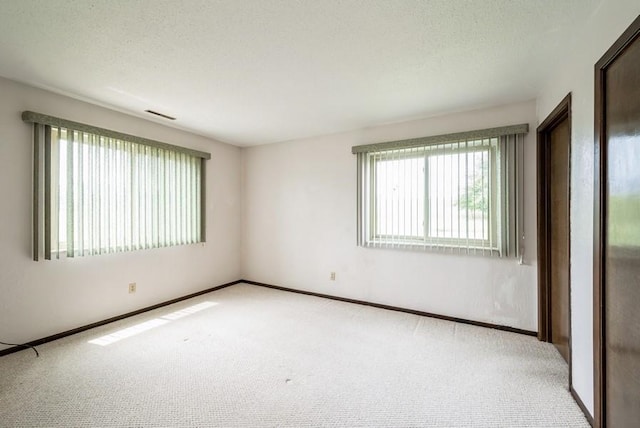 809 Kerry Ln SE Unit 66, Cedar Rapids, IA 52403 - carpeted empty room with a textured ceiling