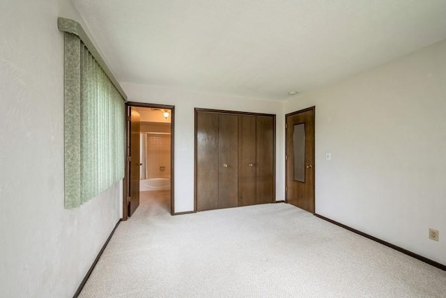 809 Kerry Ln SE Unit 66, Cedar Rapids, IA 52403 - unfurnished bedroom with light carpet, a closet, and ensuite bath