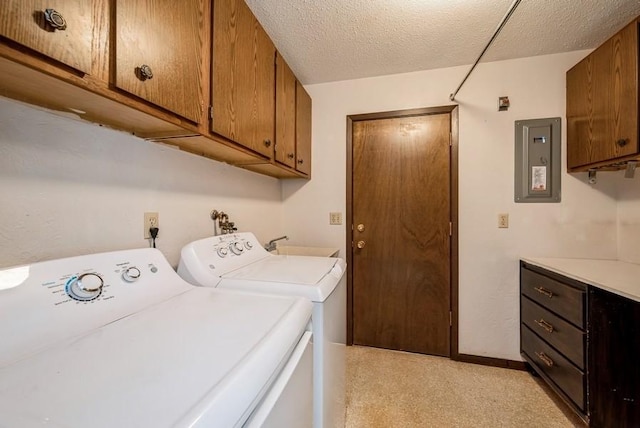809 Kerry Ln SE Unit 66, Cedar Rapids, IA 52403 - laundry area with washer and dryer, cabinet space, electric panel, and a textured ceiling