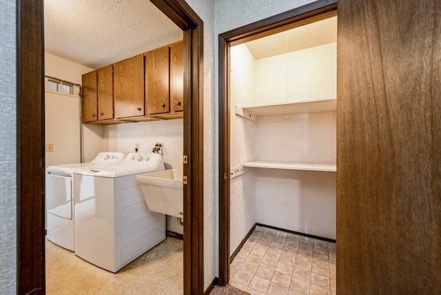 809 Kerry Ln SE Unit 66, Cedar Rapids, IA 52403 - laundry room featuring cabinet space, separate washer and dryer, and a textured ceiling