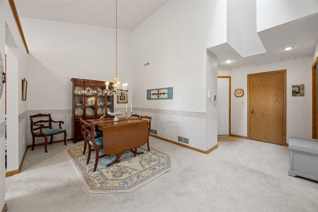4710 Westchester Dr NE Unit C, Cedar Rapids, IA 52402 - carpeted dining area featuring high vaulted ceiling, a chandelier, a wainscoted wall, and recessed lighting
