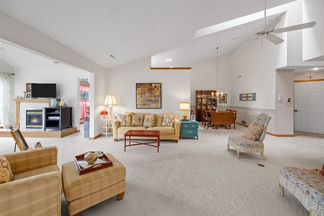 4710 Westchester Dr NE Unit C, Cedar Rapids, IA 52402 - living room featuring carpet, ceiling fan, a tile fireplace, a chandelier, and high vaulted ceiling