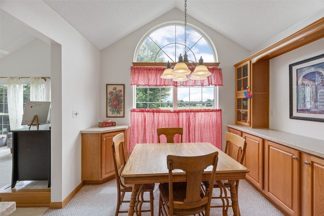 4710 Westchester Dr NE Unit C, Cedar Rapids, IA 52402 - dining space with a chandelier, light carpet, and lofted ceiling