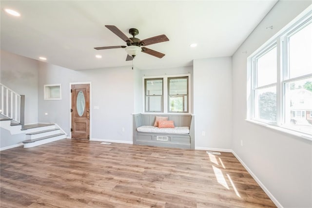 111 Maple St, Luzerne, IA 52257 - unfurnished living room featuring plenty of natural light, wood finished floors, stairs, a ceiling fan, and recessed lighting