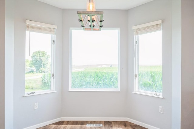 111 Maple St, Luzerne, IA 52257 - unfurnished dining area with wood finished floors and baseboards