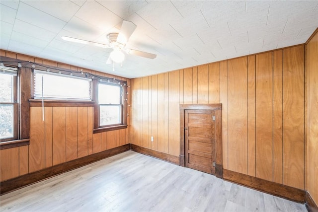 111 Maple St, Luzerne, IA 52257 - spare room with wood finished floors, ceiling fan, and wooden walls