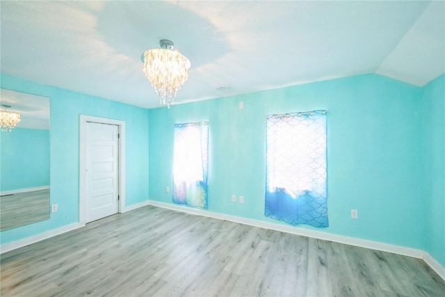 111 Maple St, Luzerne, IA 52257 - unfurnished bedroom with a chandelier and wood finished floors