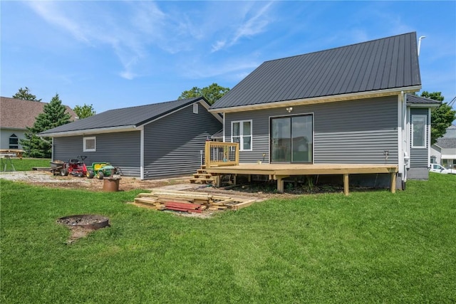 111 Maple St, Luzerne, IA 52257 - back of house with a wooden deck, a metal roof, and a lawn
