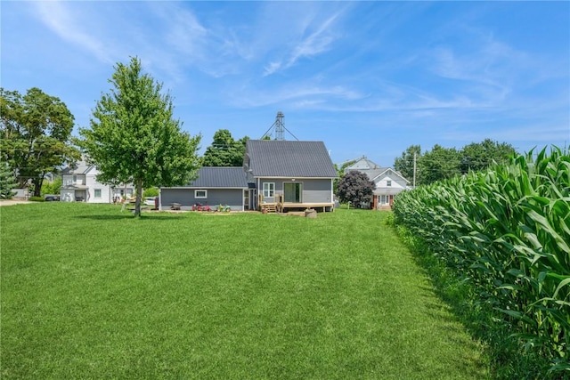 111 Maple St, Luzerne, IA 52257 - rear view of house with a lawn, a wooden deck, and a metal roof