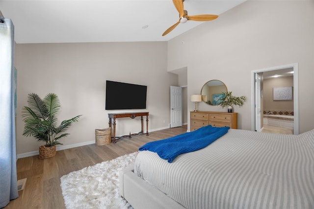 422 Rock Ridge Rd NW, Cedar Rapids, IA 52405 - bedroom featuring wood finished floors, high vaulted ceiling, ensuite bath, and ceiling fan