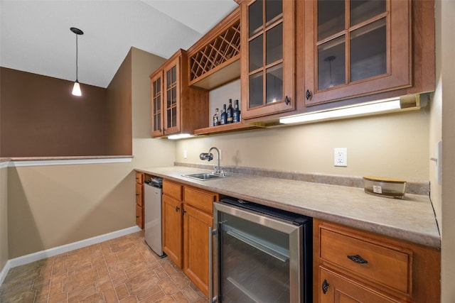 422 Rock Ridge Rd NW, Cedar Rapids, IA 52405 - indoor wet bar with wine cooler, hanging light fixtures, vaulted ceiling, stone finish floors, and dishwasher