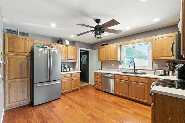 2113 Ridgewood Ave, Muscatine, IA 52761 - kitchen featuring stainless steel appliances, a ceiling fan, light countertops, light wood-type flooring, and recessed lighting
