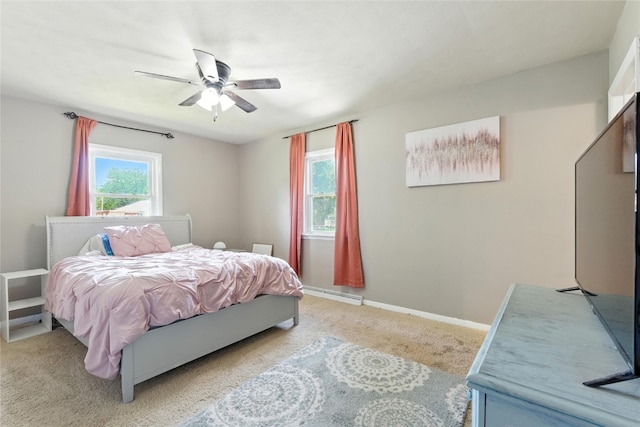 2113 Ridgewood Ave, Muscatine, IA 52761 - bedroom with light carpet, baseboard heating, and ceiling fan