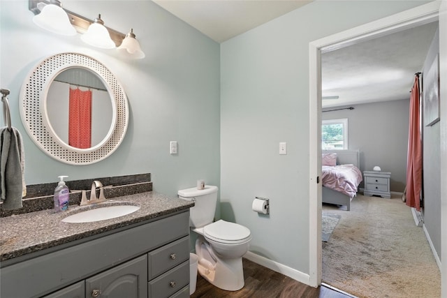 2113 Ridgewood Ave, Muscatine, IA 52761 - bathroom featuring vanity, ensuite bathroom, wood finished floors, and curtained shower