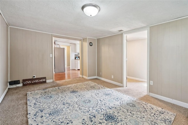 100 W Short St, Solon, IA 52333 - carpeted spare room with a textured ceiling and wood walls