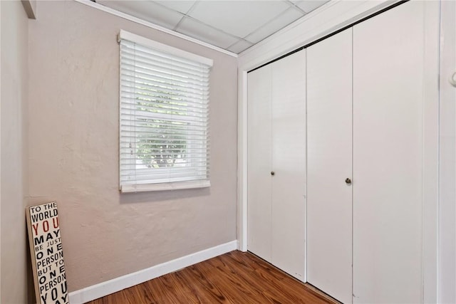 100 W Short St, Solon, IA 52333 - unfurnished bedroom featuring a closet, wood finished floors, and a drop ceiling