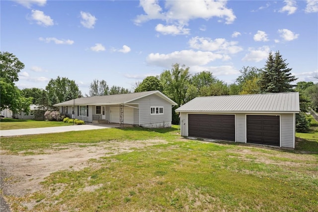 75 Jefferson Ave SW, Swisher, IA 52238 - view of front of house featuring a detached garage, a front lawn, and an outbuilding