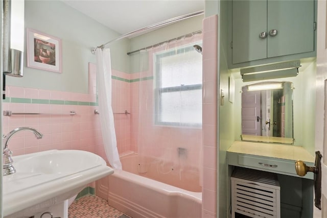 1727 Grande Ave SE, Cedar Rapids, IA 52403 - bathroom featuring tile walls, shower / bath combo, tile patterned floors, and wainscoting