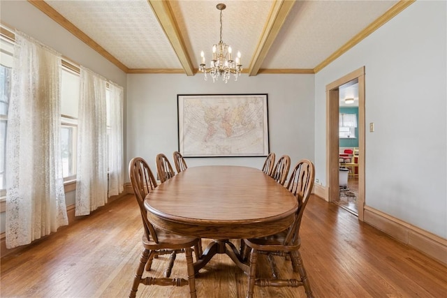 1727 Grande Ave SE, Cedar Rapids, IA 52403 - dining space featuring a chandelier, light wood-style flooring, healthy amount of natural light, beam ceiling, and crown molding