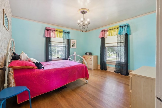 1727 Grande Ave SE, Cedar Rapids, IA 52403 - bedroom with wood finished floors, a chandelier, and crown molding