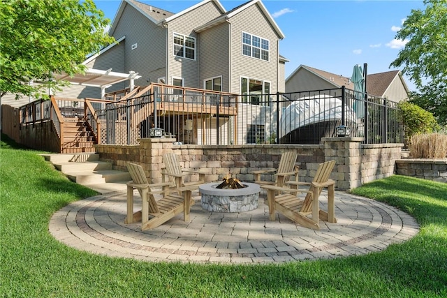 3037 Brookfield Dr, Marion, IA 52302 - rear view of property featuring stairway, a fire pit, a wooden deck, a lawn, and a patio area